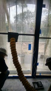 Test chamber on the inside of a sliding glass door for E1105 to recreate wind driven rain conditions.