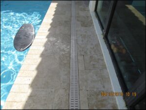 Trench drain that only allows water to drain at the finished walking surface