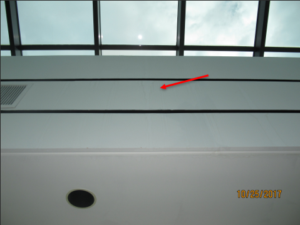 Visible water intrusion and staining on the wall beneath a skylight curb.